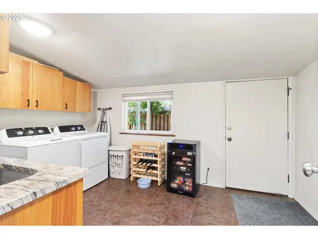 a kitchen with stainless steel appliances granite countertop a stove a sink and a refrigerator with wooden cabinets