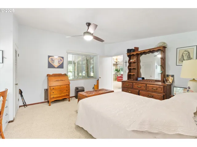 a bedroom with a bed dresser and a window