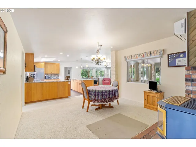 a living room with furniture and a dining table with kitchen view