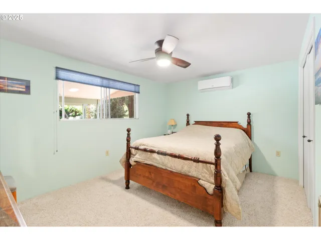 a bedroom with a bed and a painting on the wall