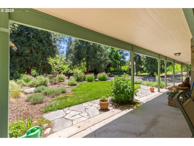 a view of a patio with table and chairs potted plants with wooden floor