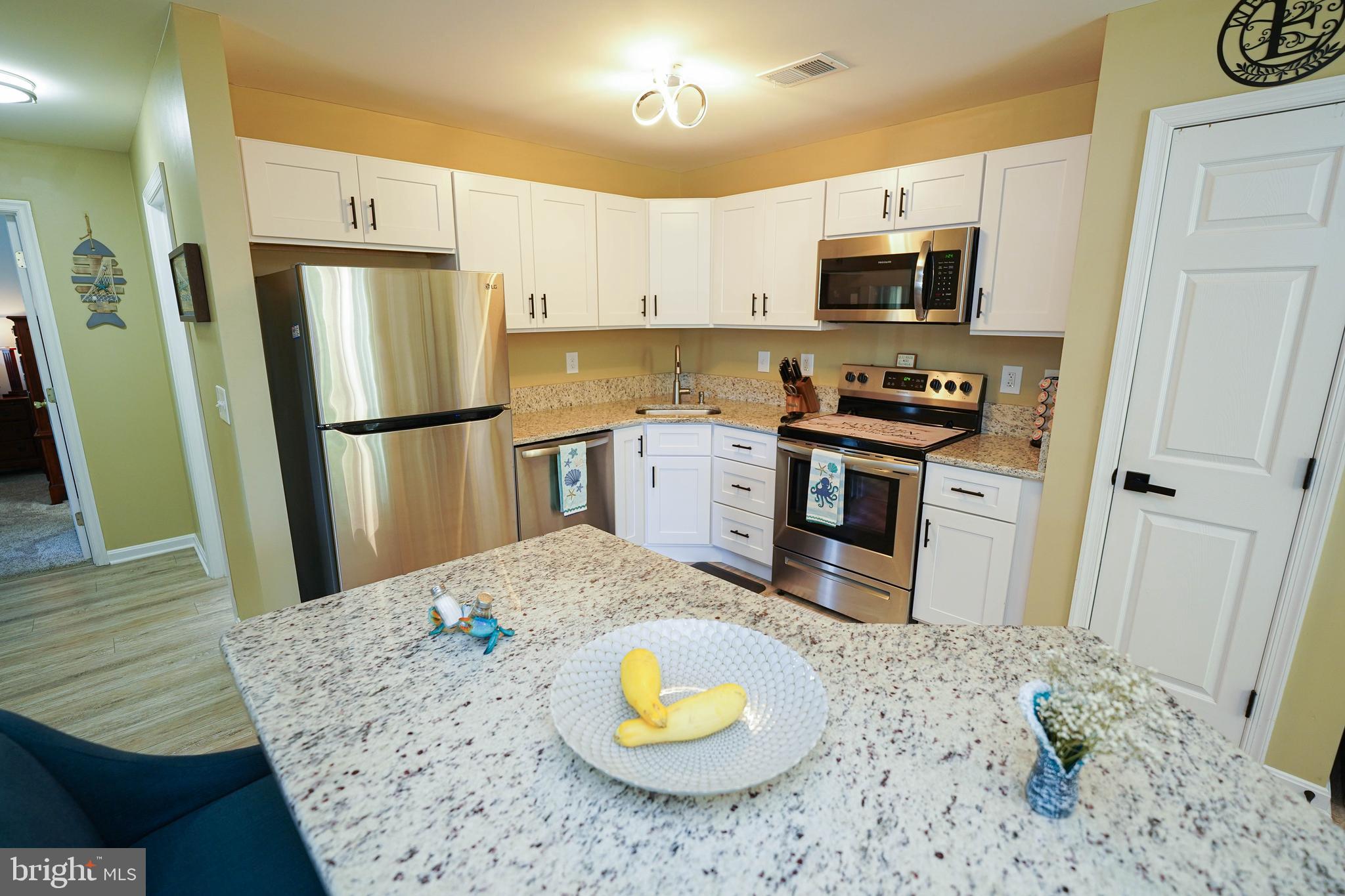 11421 Manklin Creek Road, Unit 4 Berlin, MD 21811 - Photo 11 of 47 Bright open kitchen w/ stainless steel appliances