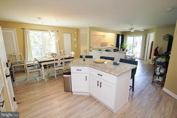 a very nice looking living room with dining room and wooden floor