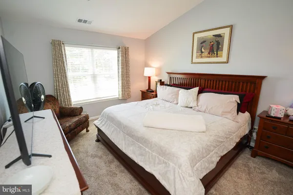 a bedroom with bed and window