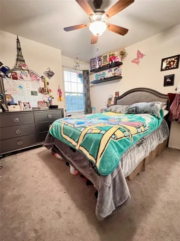 a bedroom with bed and a chandelier