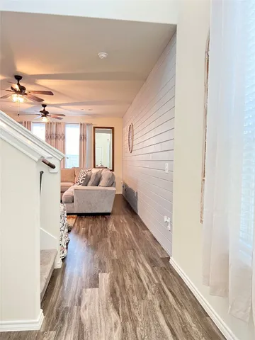 a living room with furniture and a wooden floor