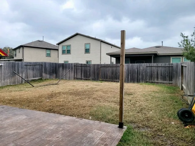 a backyard of a house with barbeque oven