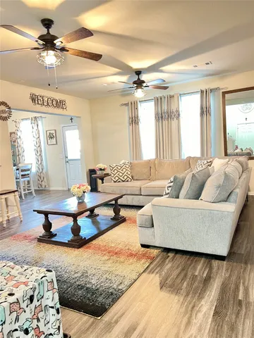a living room with furniture and a chandelier