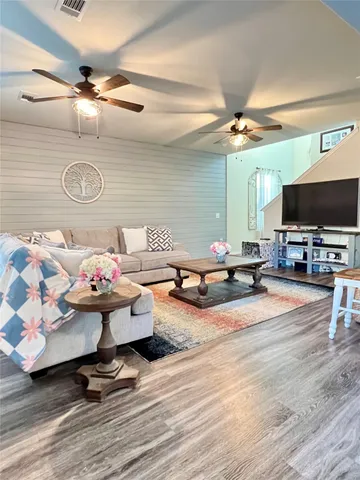 a living room with furniture and a flat screen tv