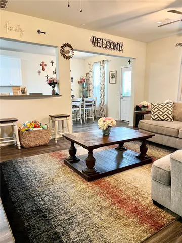 a living room with furniture and wooden floor