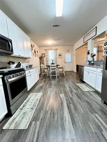 a kitchen with wooden floors and a stove