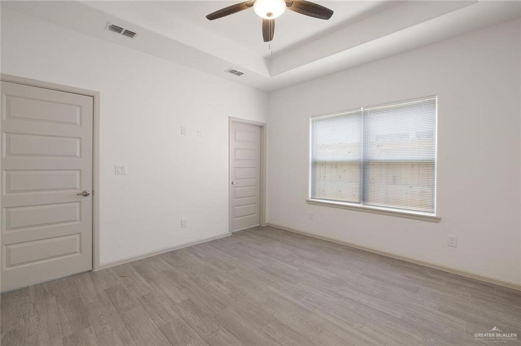 740 North Alamo Road, Unit 20 Alamo, TX 78516 - Photo 4 of 11 an empty room with ceiling fan and window