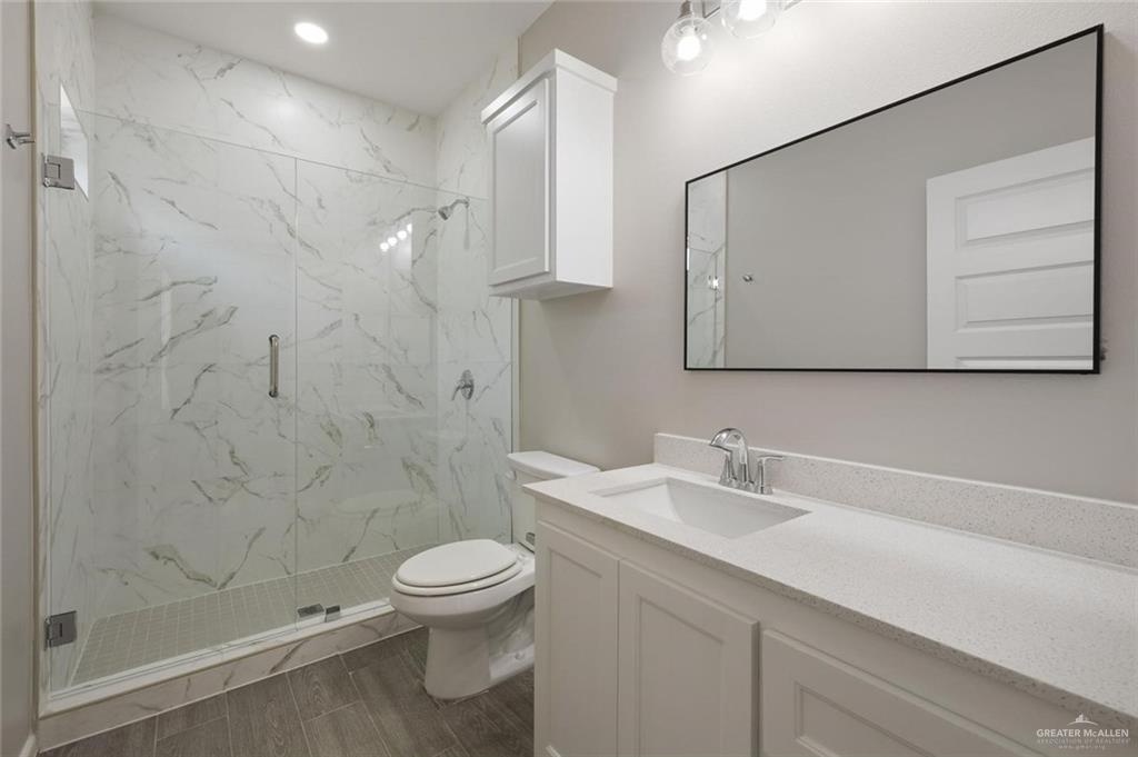 740 North Alamo Road, Unit 20 Alamo, TX 78516 - Photo 6 of 11 a bathroom with a sink a toilet and shower