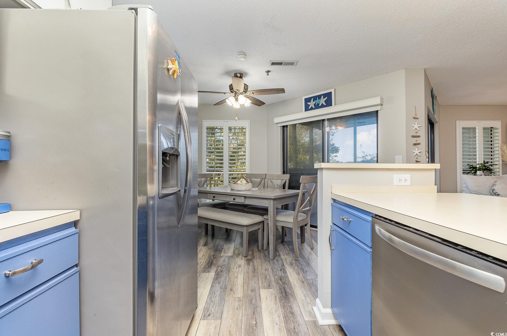1101 Possum Trot Road, Unit B203 North Myrtle Beach, SC 29582 - Photo 12 of 37 Kitchen with ceiling fan, blue cabinets, a texture