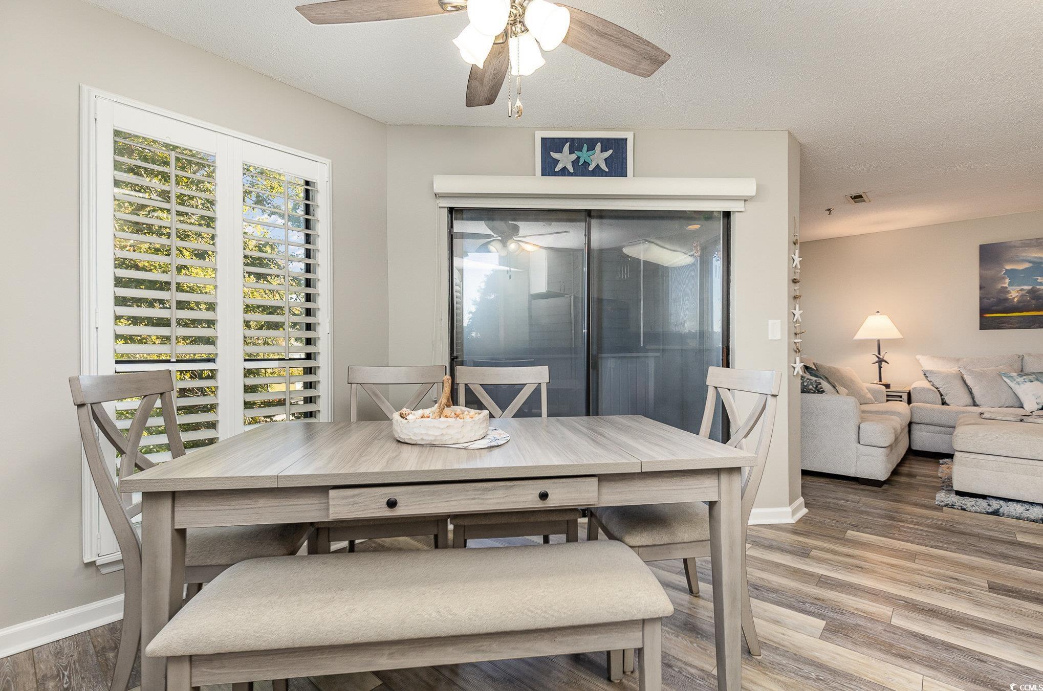 1101 Possum Trot Road, Unit B203 North Myrtle Beach, SC 29582 - Photo 13 of 37 Dining area featuring hardwood / wood-style floori