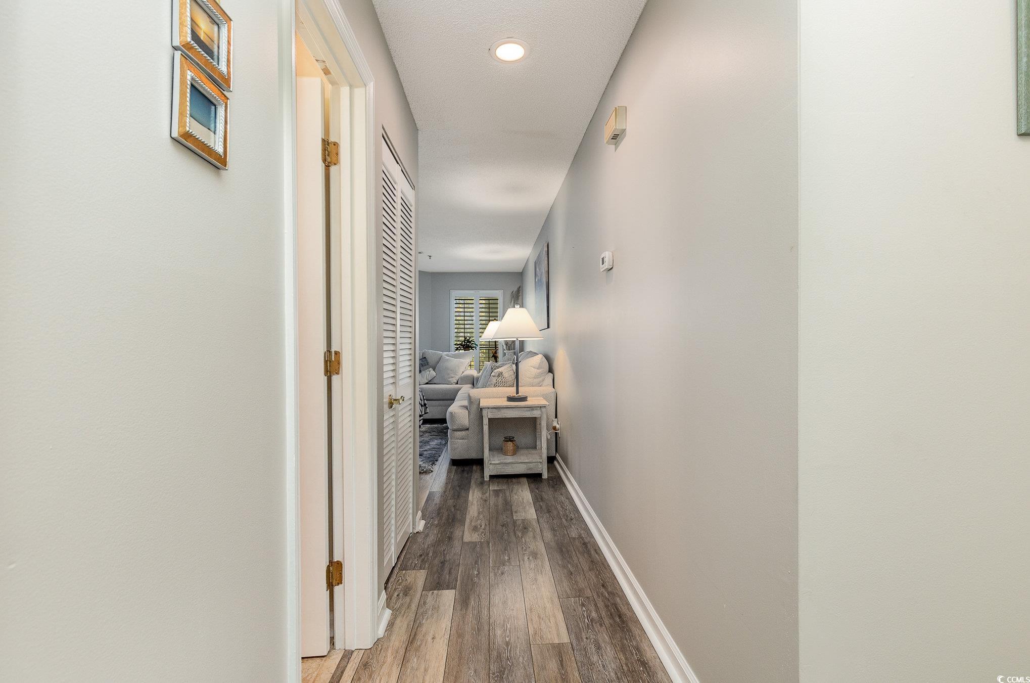 1101 Possum Trot Road, Unit B203 North Myrtle Beach, SC 29582 - Photo 16 of 37 Hallway featuring hardwood / wood-style flooring