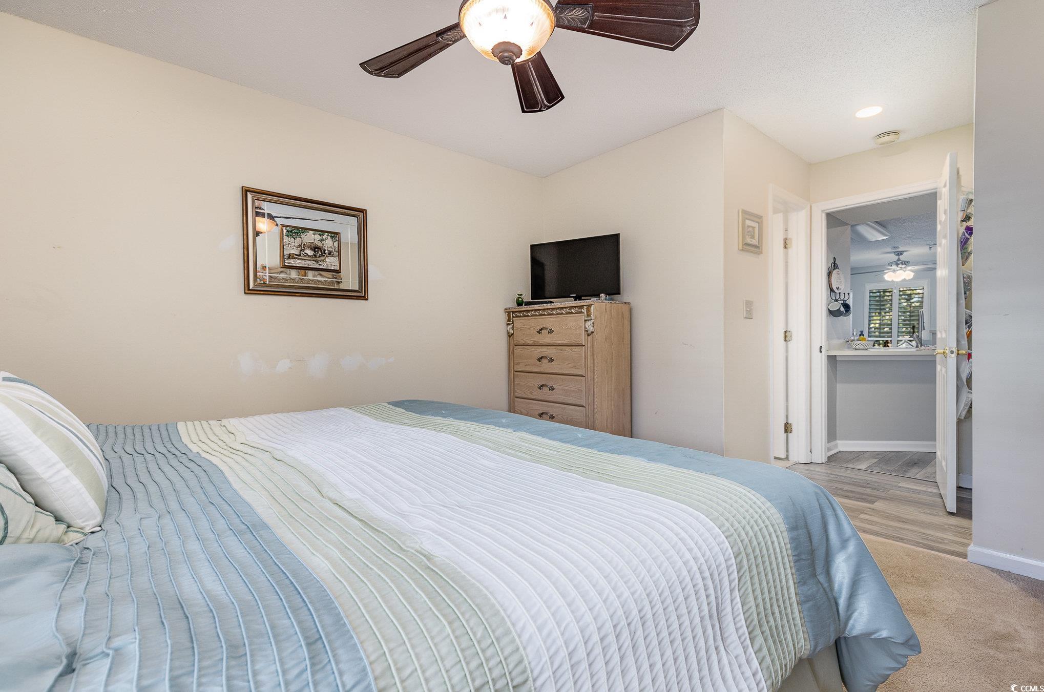 1101 Possum Trot Road, Unit B203 North Myrtle Beach, SC 29582 - Photo 18 of 37 Bedroom featuring ceiling fan and light hardwood /