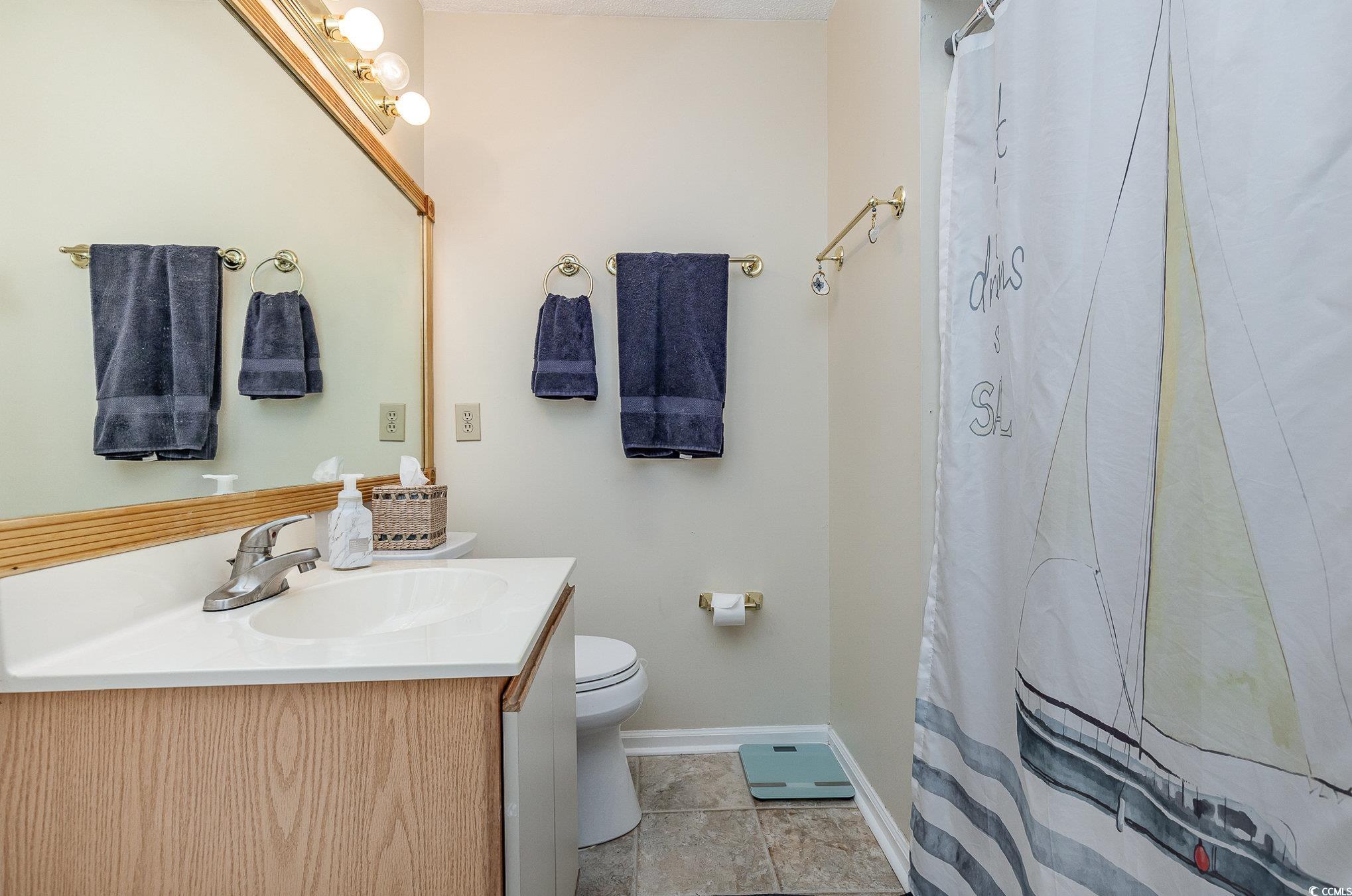 1101 Possum Trot Road, Unit B203 North Myrtle Beach, SC 29582 - Photo 20 of 37 Bathroom featuring tile patterned flooring, curtai