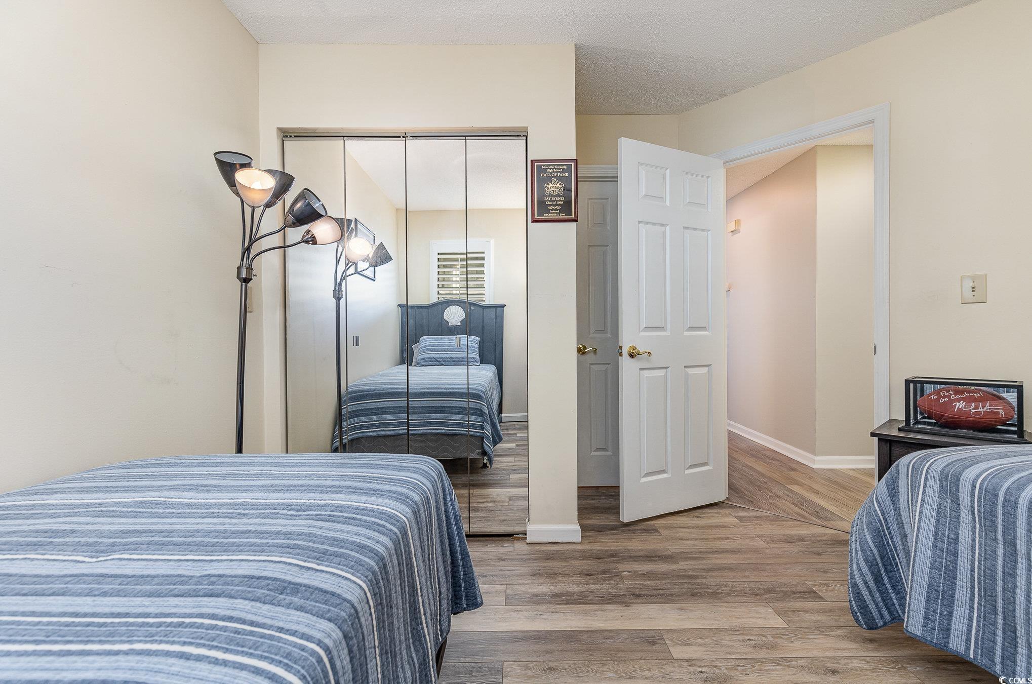 1101 Possum Trot Road, Unit B203 North Myrtle Beach, SC 29582 - Photo 23 of 37 Bedroom with a closet and hardwood / wood-style fl
