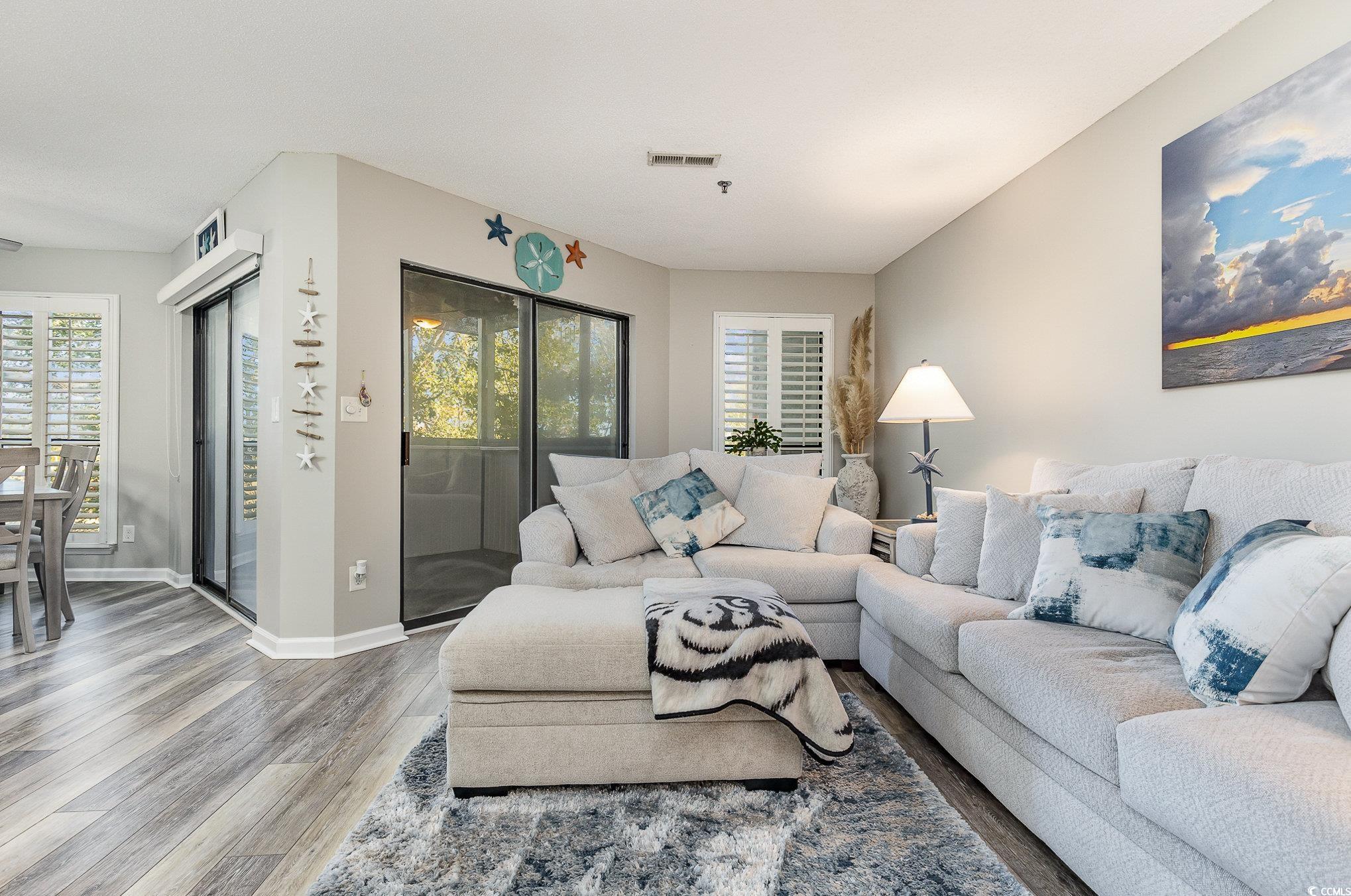 Living room with hardwood / wood-style flooring