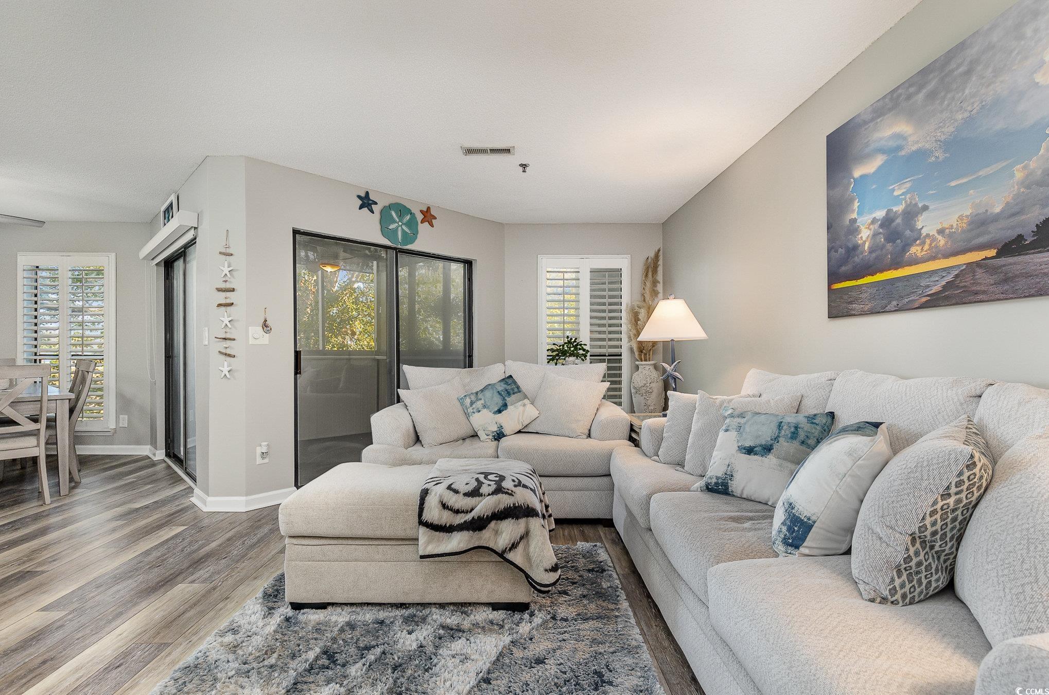 Living room with hardwood / wood-style flooring