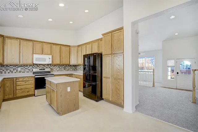 a kitchen with stainless steel appliances granite countertop white cabinets and a granite counter tops