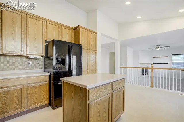 a large kitchen with kitchen island a sink stainless steel appliances and cabinets