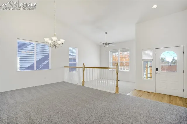 an empty room with windows and entrance