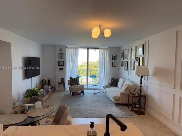 a living room with furniture wooden floor and a flat screen tv