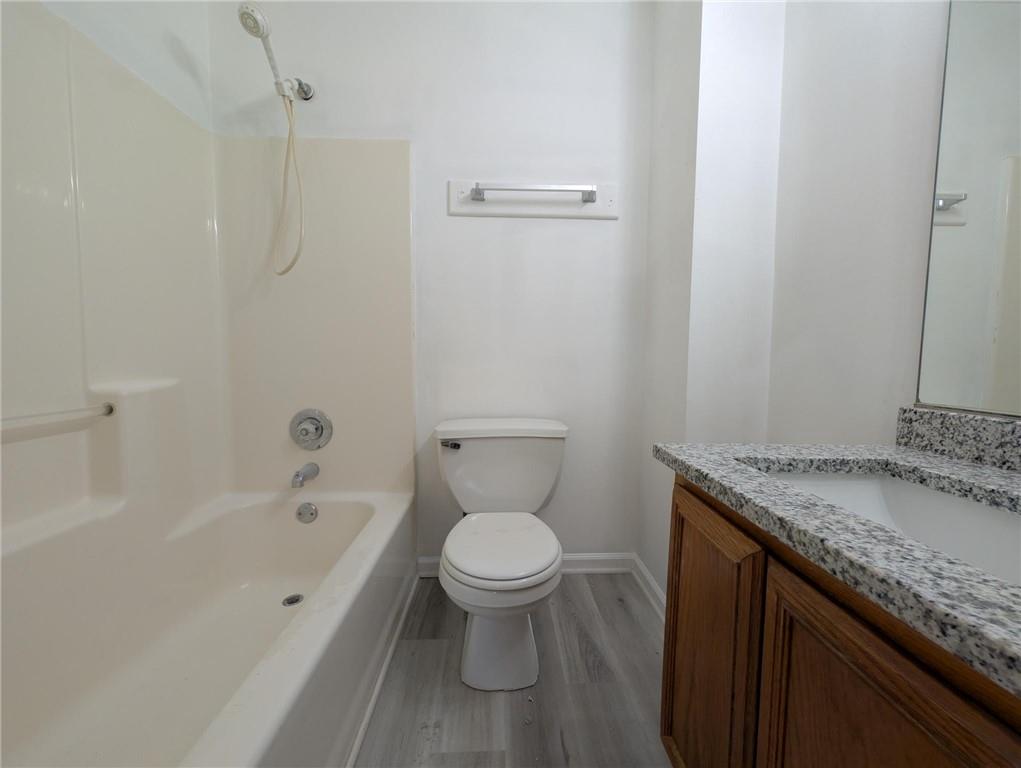 4351 Logan Way Acworth, GA 30101 - Photo 11 of 11 a bathroom with a granite countertop toilet a sink and a bathtub