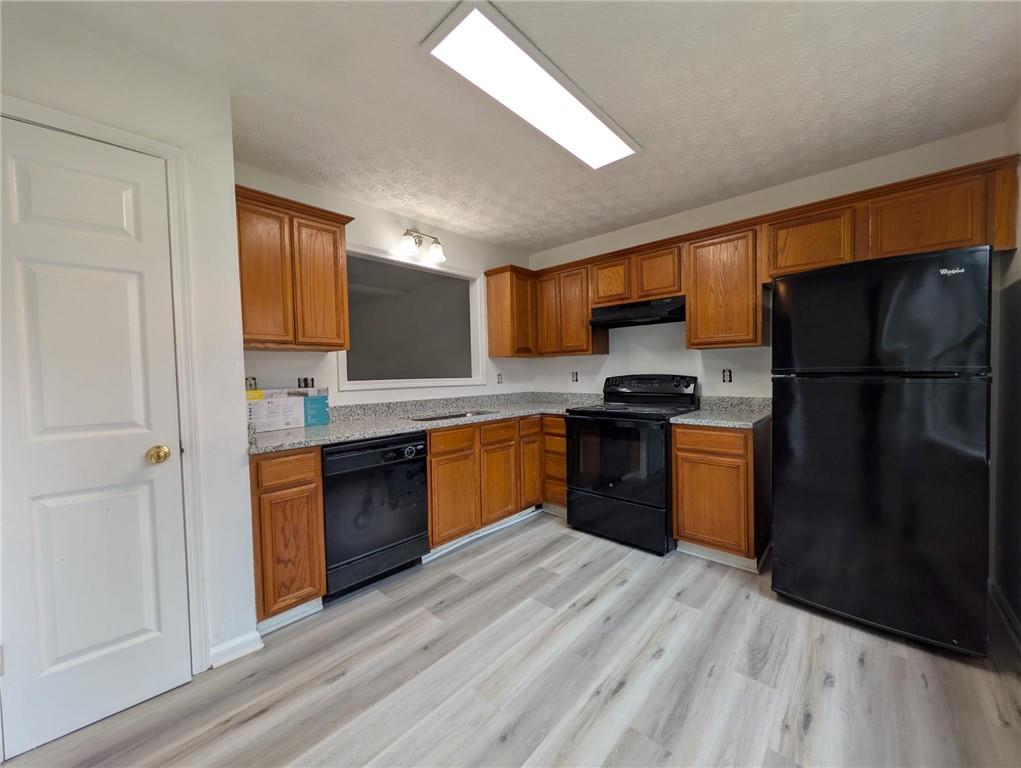 4351 Logan Way Acworth, GA 30101 - Photo 3 of 11 a kitchen with stainless steel appliances granite countertop a refrigerator stove and sink