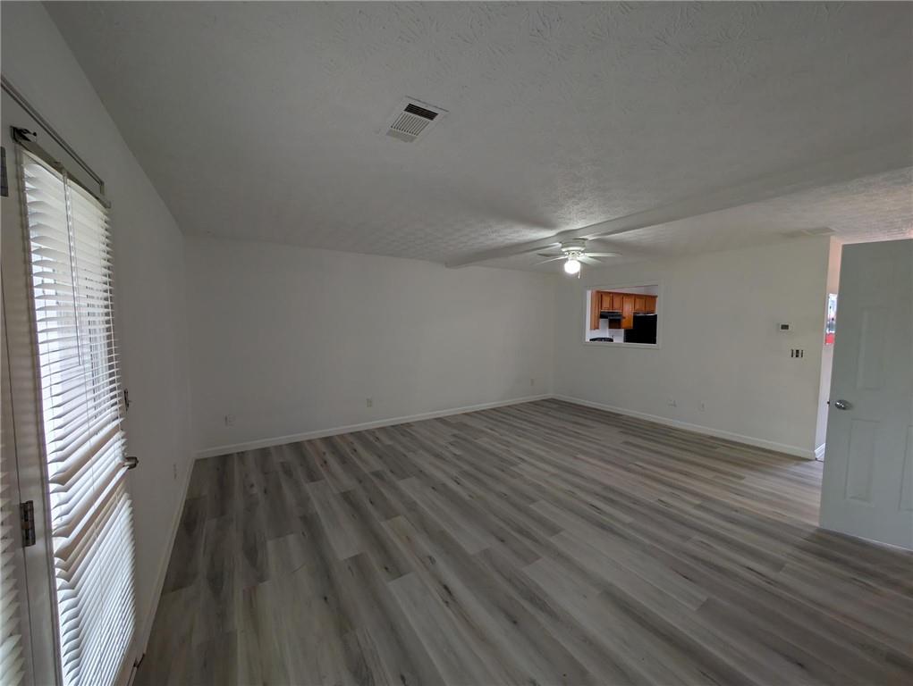 4351 Logan Way Acworth, GA 30101 - Photo 4 of 11 a view of wooden floor and windows in an empty room