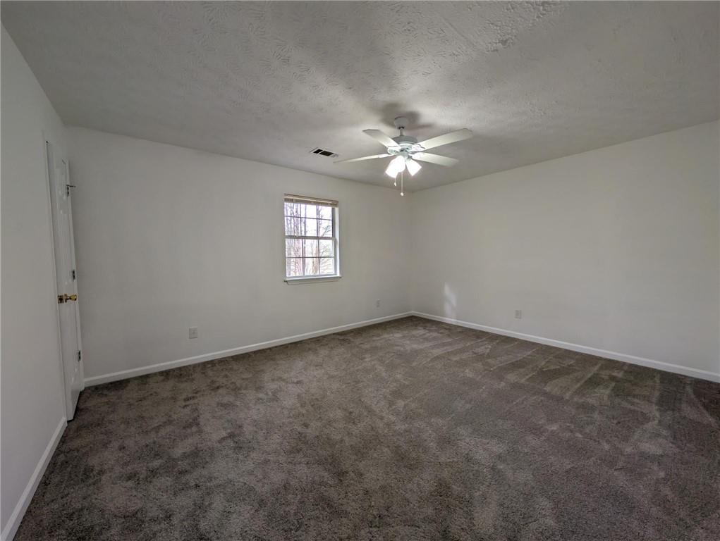 4351 Logan Way Acworth, GA 30101 - Photo 8 of 11 an empty room with windows and fan