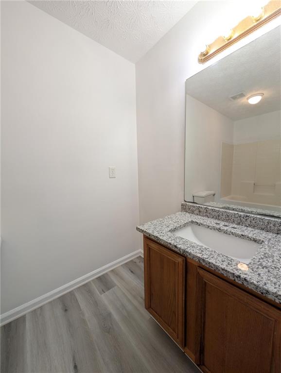 4351 Logan Way Acworth, GA 30101 - Photo 9 of 11 a bathroom with a granite countertop sink and a mirror