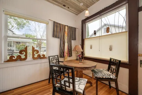a view of a dining room with furniture window and wooden floor