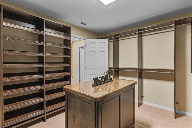 a spacious bathroom with a granite countertop sink and a mirror