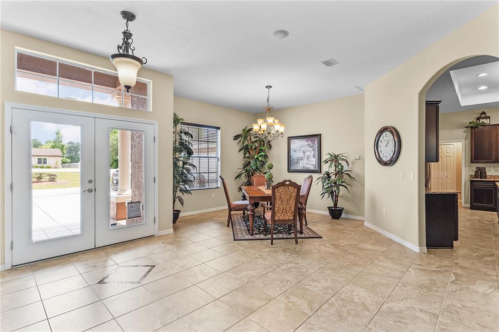 10710 Southwest 49th Avenue Ocala, FL 34476 - Photo 28 of 48 a view of a dining room with furniture window and wooden floor
