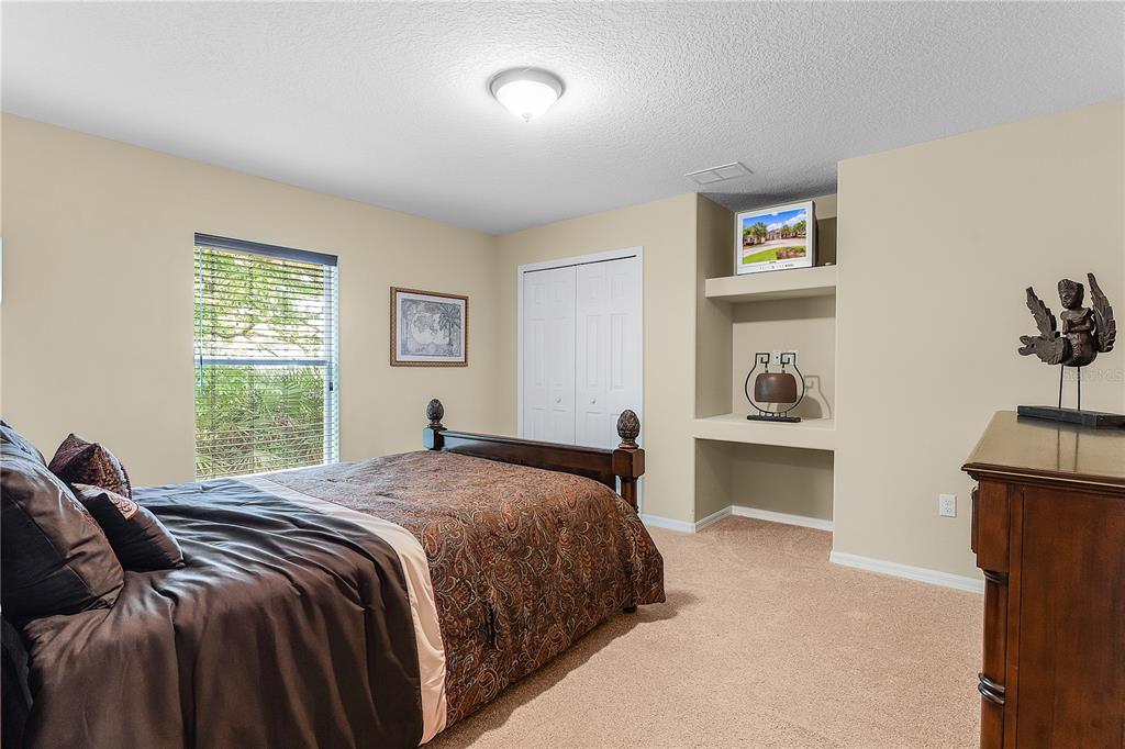 10710 Southwest 49th Avenue Ocala, FL 34476 - Photo 32 of 48 a bedroom with a bed and painting on the wall