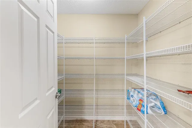a room with pool table and chairs