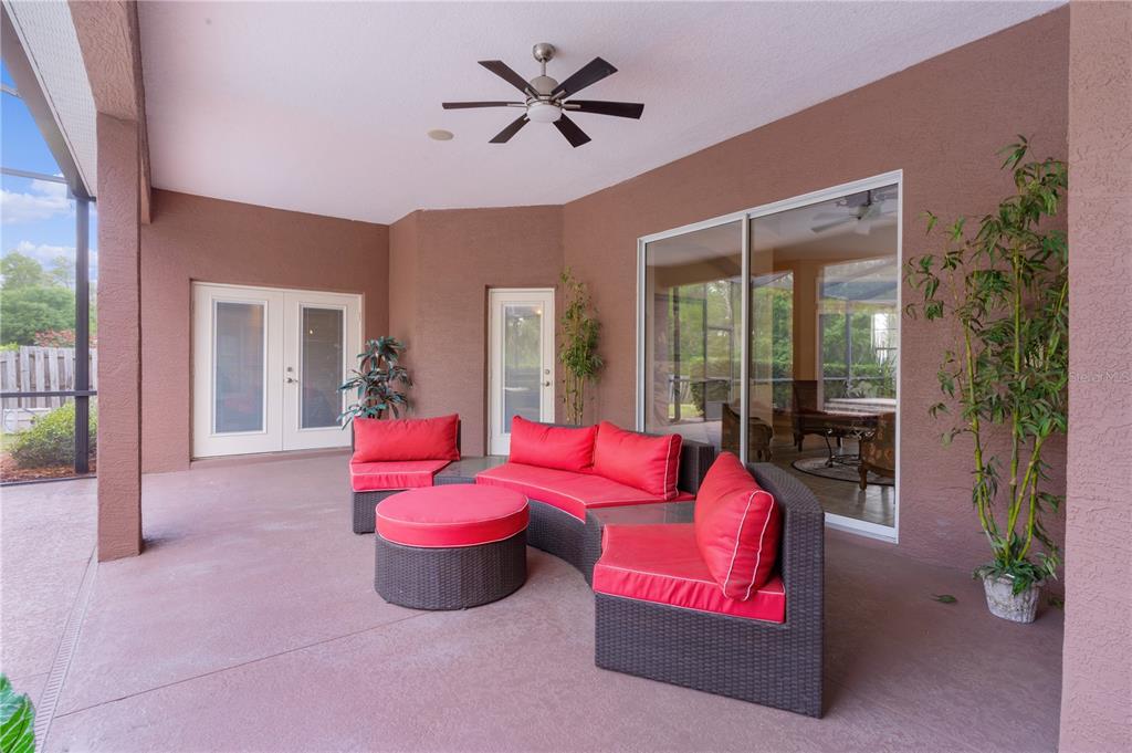 10710 Southwest 49th Avenue Ocala, FL 34476 - Photo 44 of 48 a living room with furniture floor to ceiling window and a potted plant