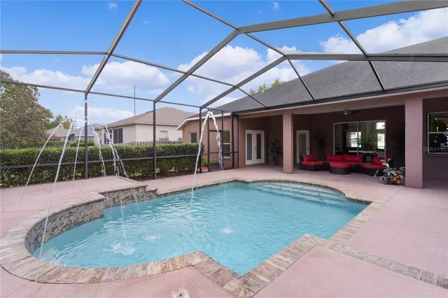 a view of a dining room with furniture and chandelier
