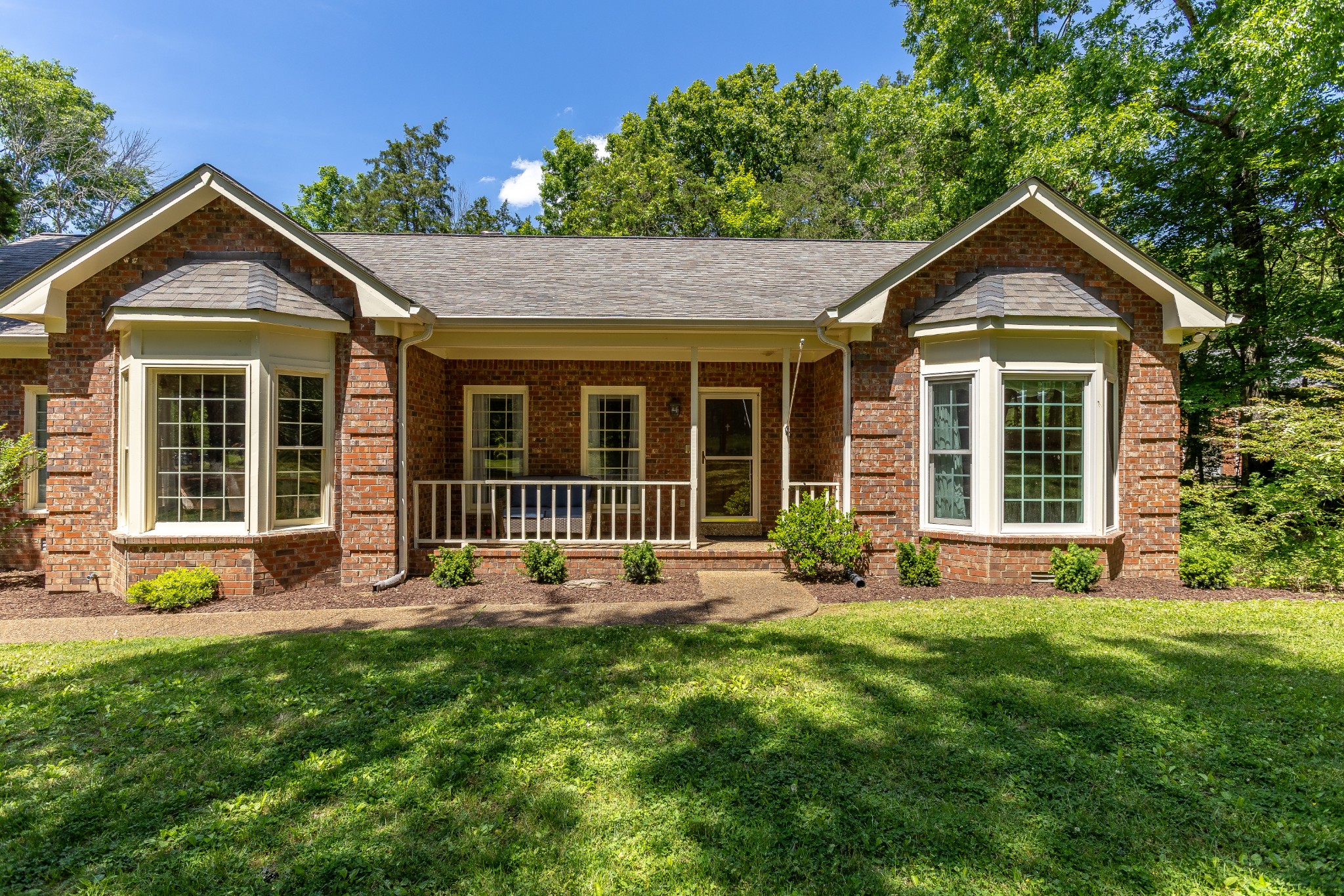 1111 Temple Ridge Court Nashville, TN 37221 - Photo 7 of 46 a front view of a house with a yard and porch