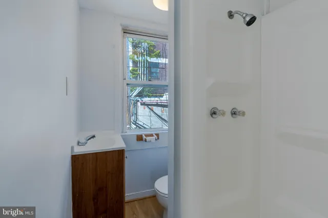 a bathroom with a toilet and a shower
