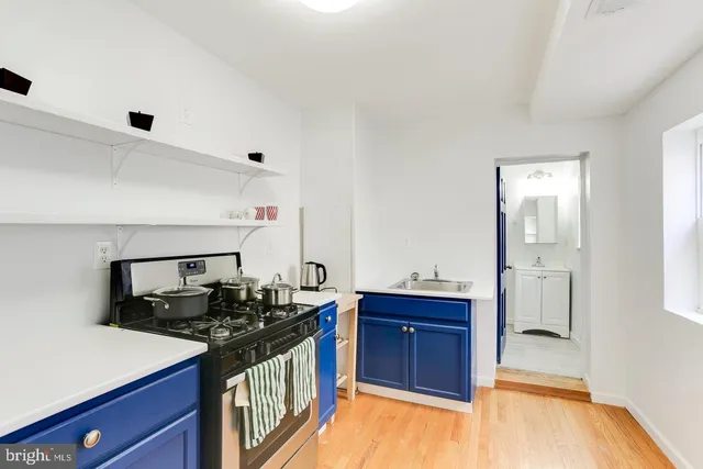 a kitchen with a sink and a stove top oven