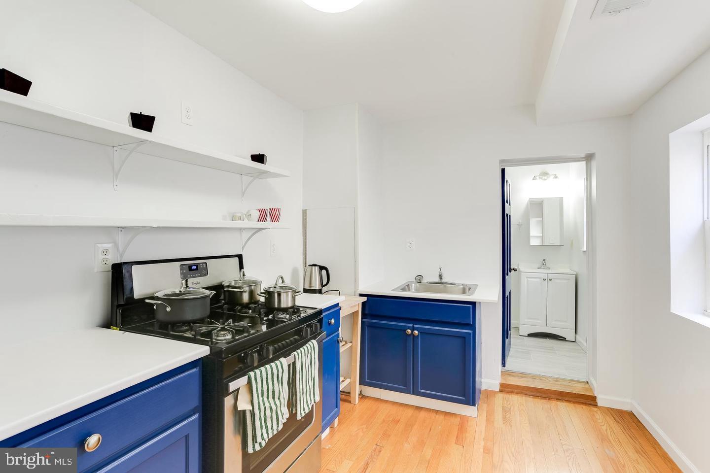 202 South Regester Street Baltimore, MD 21231 - Photo 3 of 15 a kitchen with a sink and a stove top oven