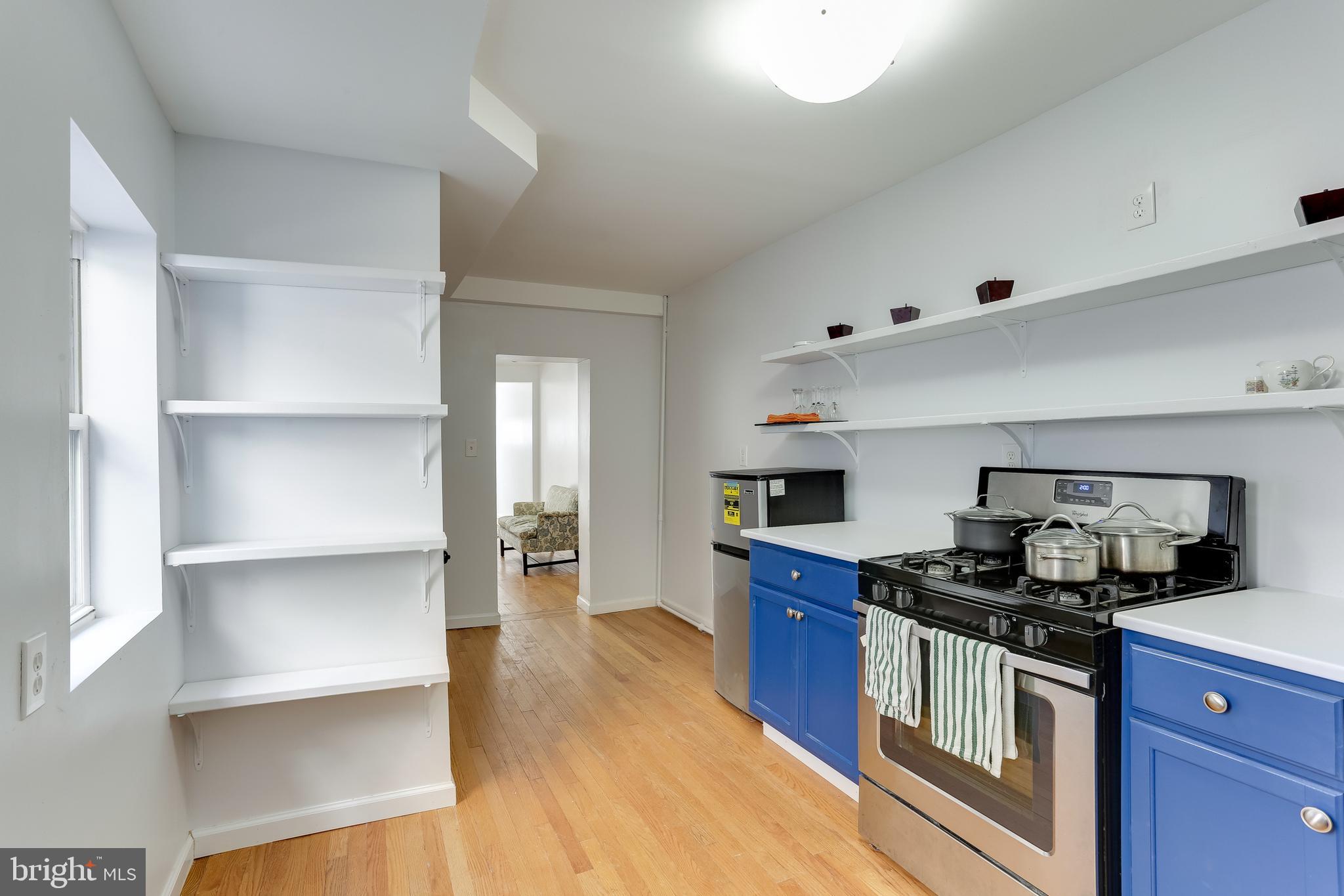 202 South Regester Street Baltimore, MD 21231 - Photo 4 of 15 a kitchen with a stove and a refrigerator