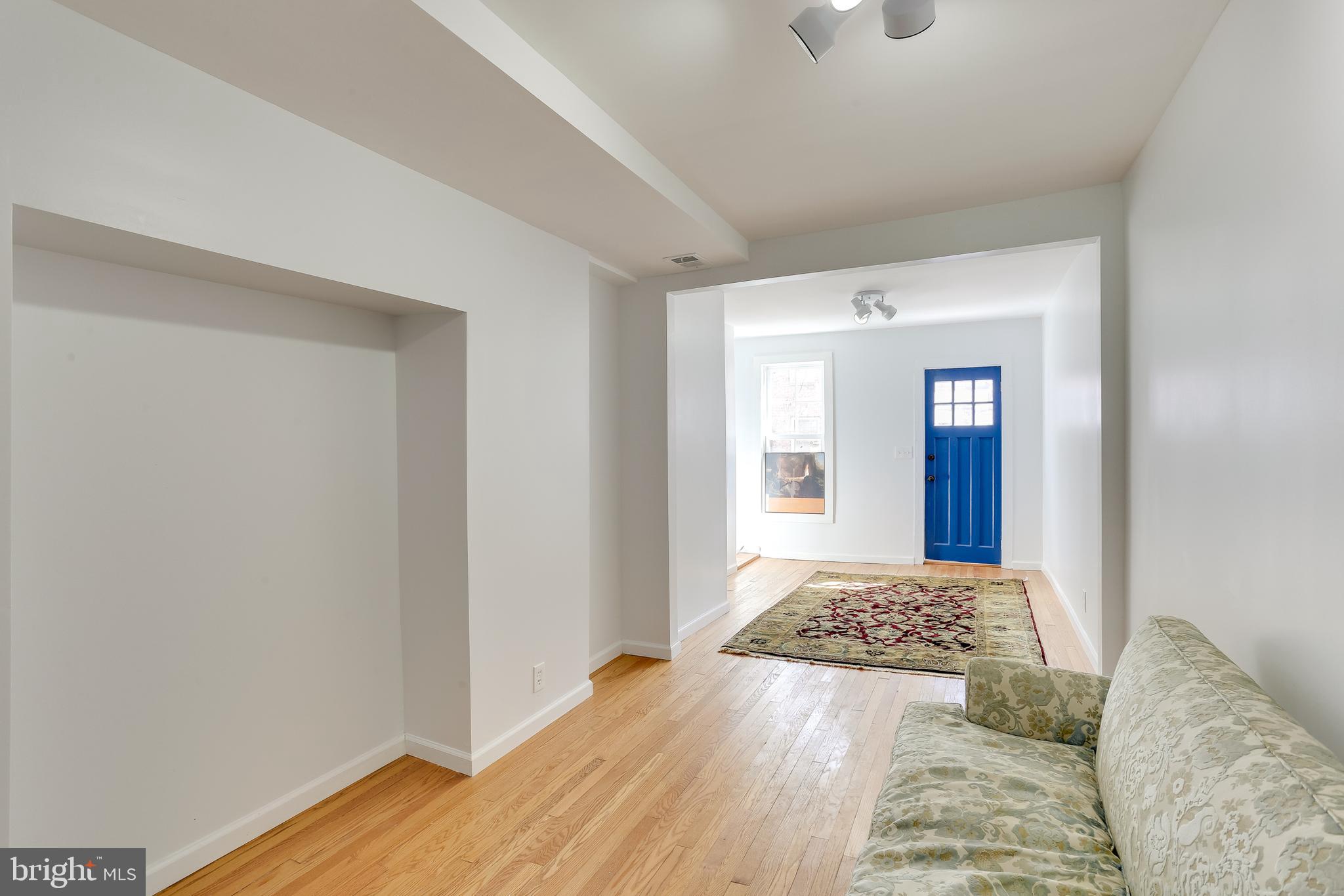 202 South Regester Street Baltimore, MD 21231 - Photo 5 of 15 a bedroom with a bed and wooden floor