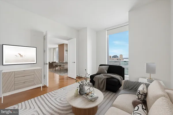 a living room with furniture and a wooden floor