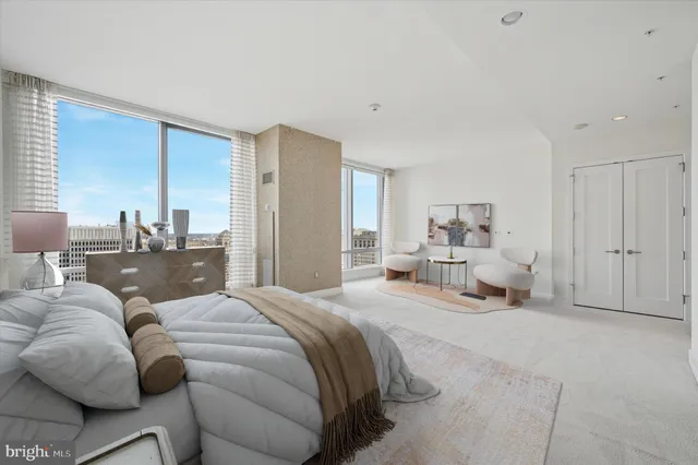 a bedroom with a bed and view of living room