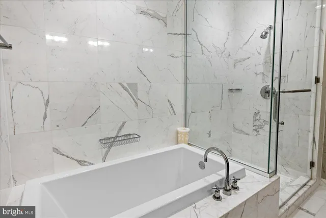 a bathroom with a bathtub and a shower